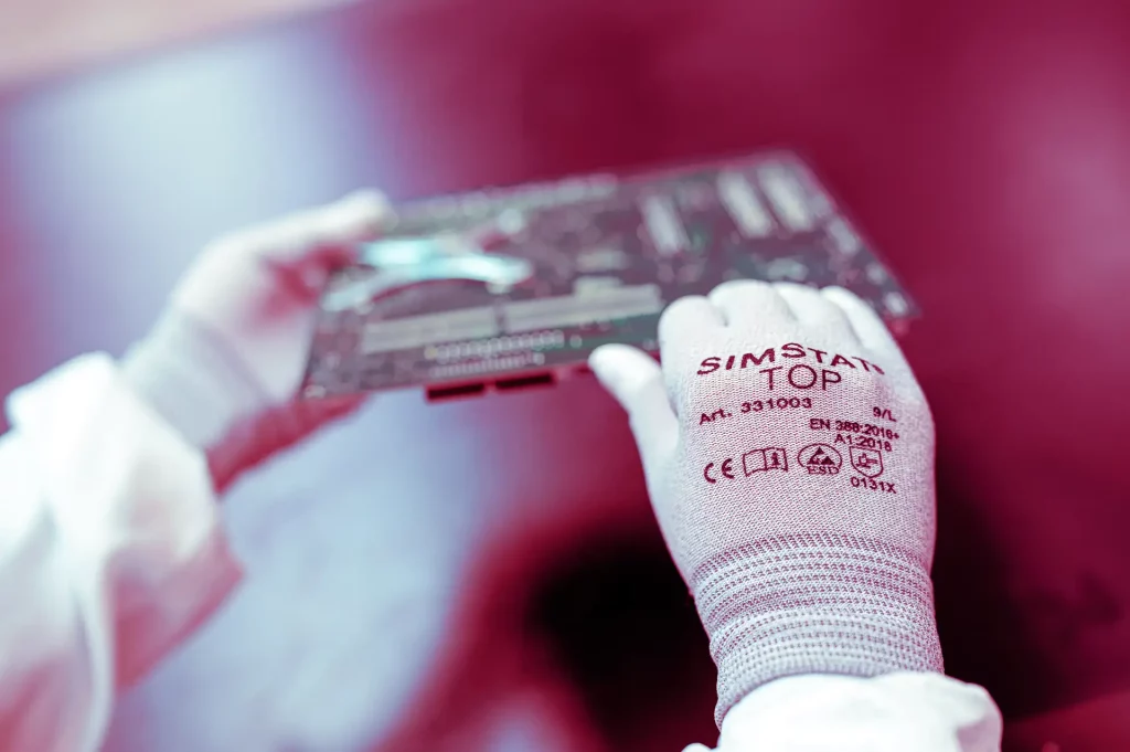 Hands in protective gloves holds semiconductor | Protect2Clean
